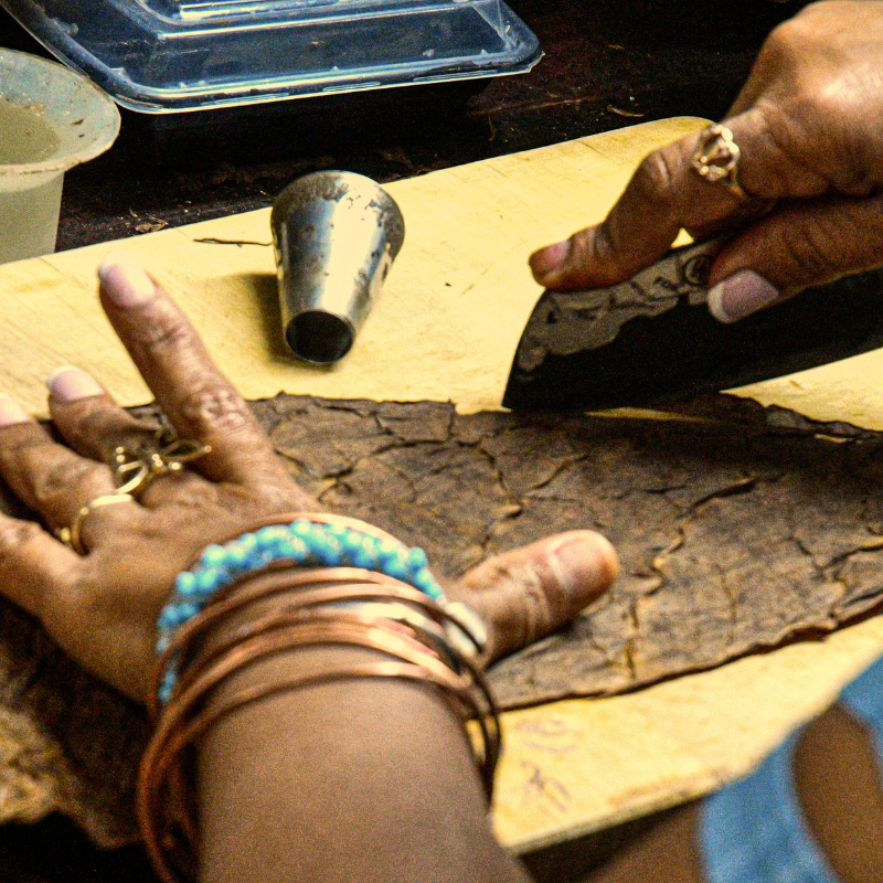 hands using a chaveta to cut the soon to be wrapper for an ETB cigar in Little Havana Miami FL
